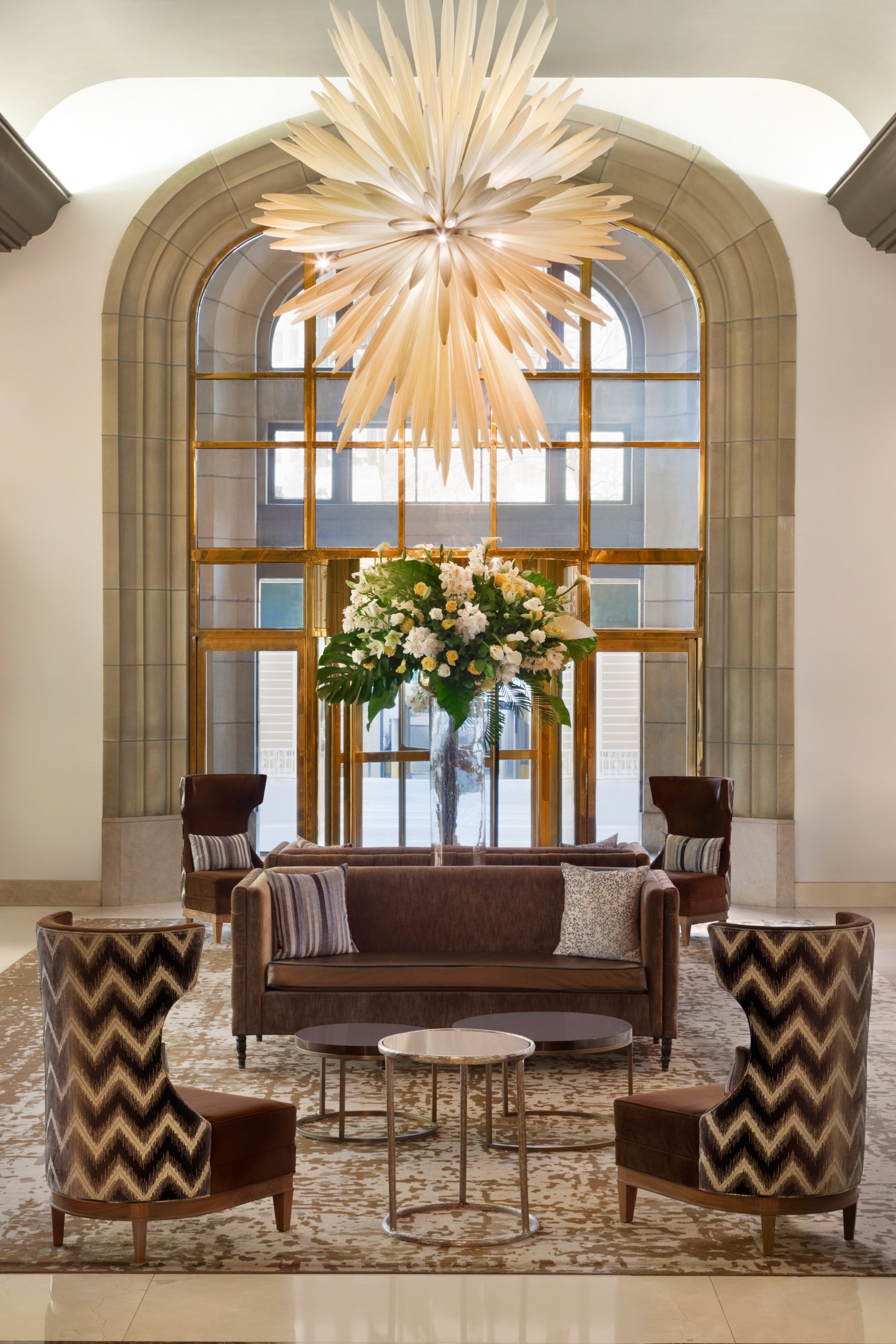 four chairs surrounding a sofa and bouquet