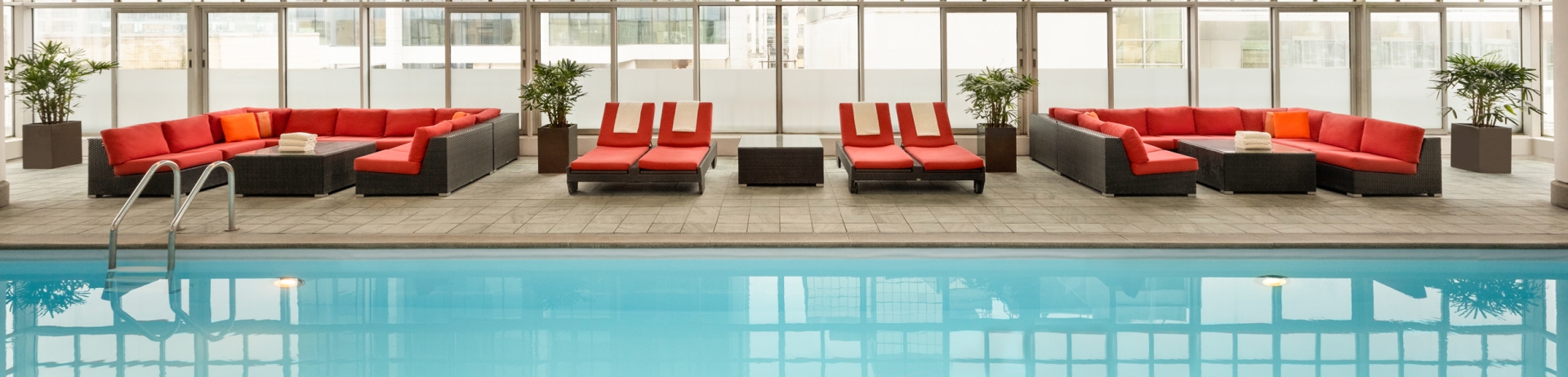 Lounge seats beside an indoor pool at Fairmont Hotel Vancouver