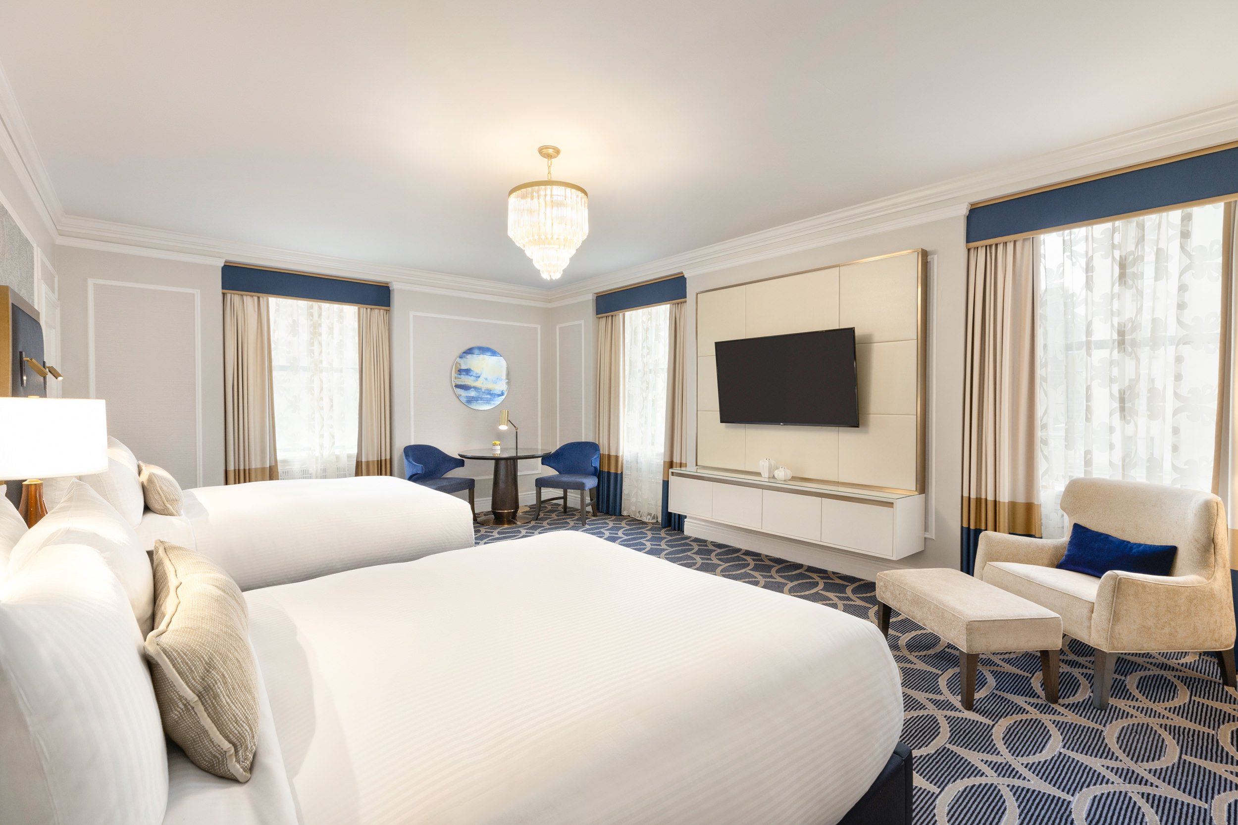 The Fairmont Gold Room with large windows and two queen-sized beds