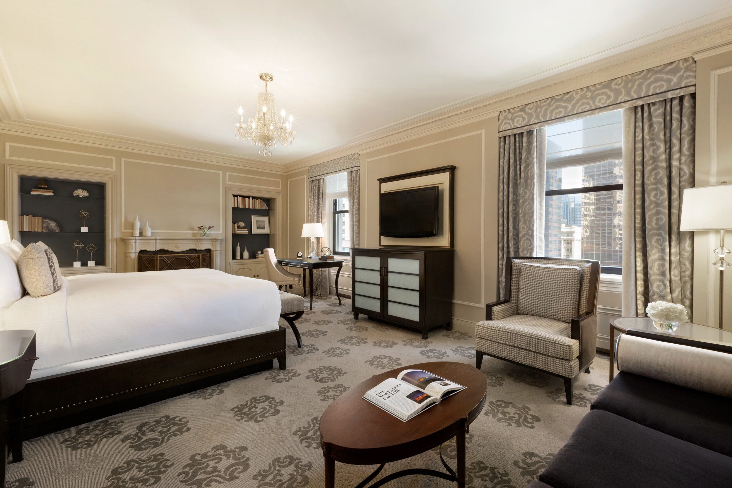 The Fairmont Junior Suite with king-sized bed, sitting area, and city views.