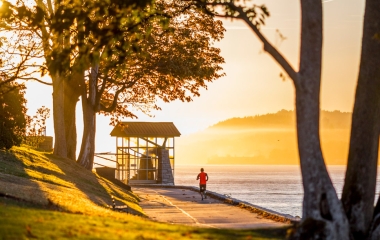 man running in stanley park at sunset