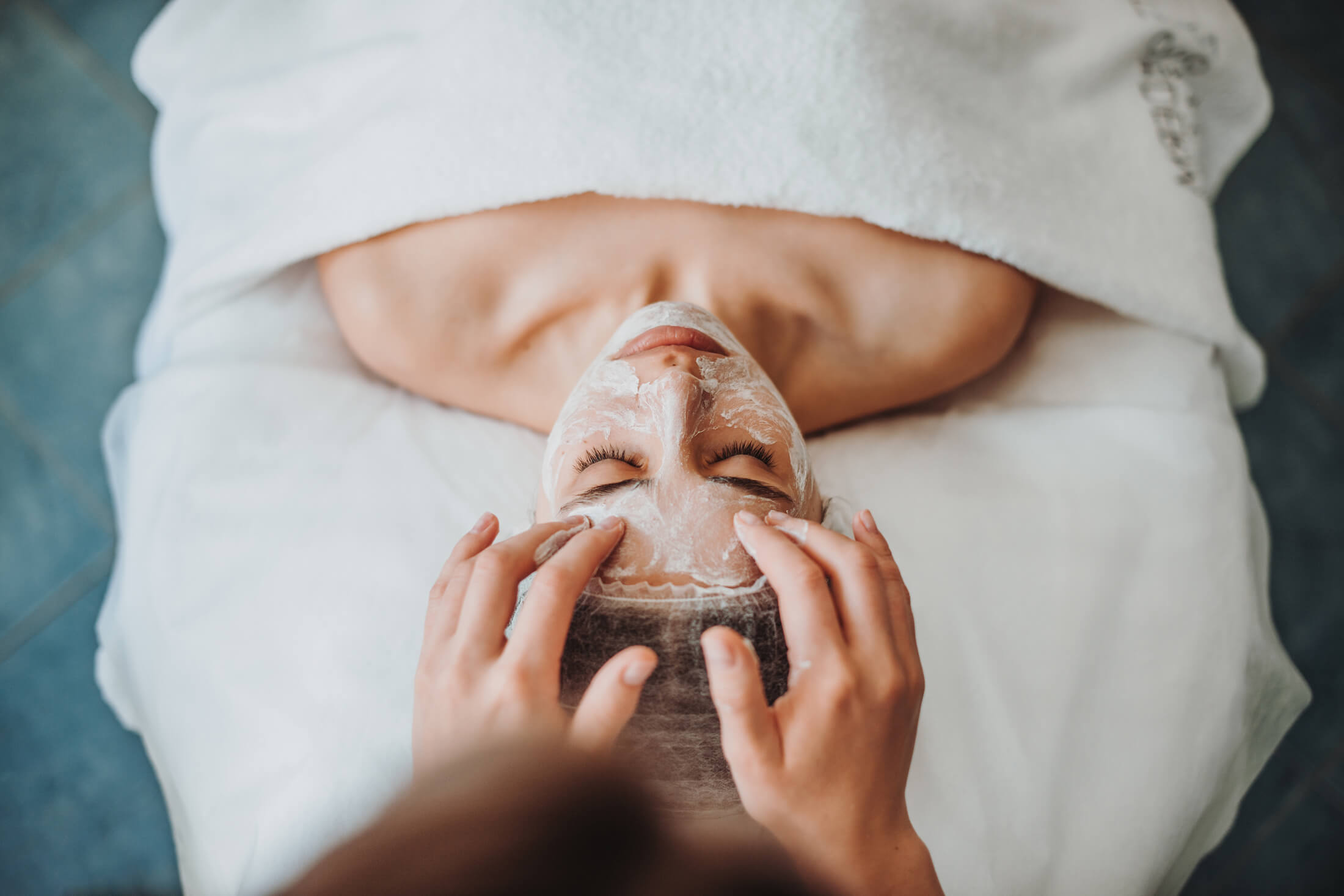 A woman getting a facial at a spa