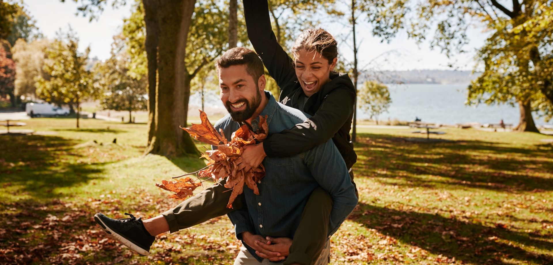 Couple playing in the park with autumn leaves Image: Destination Vancouver/Hubert Kang