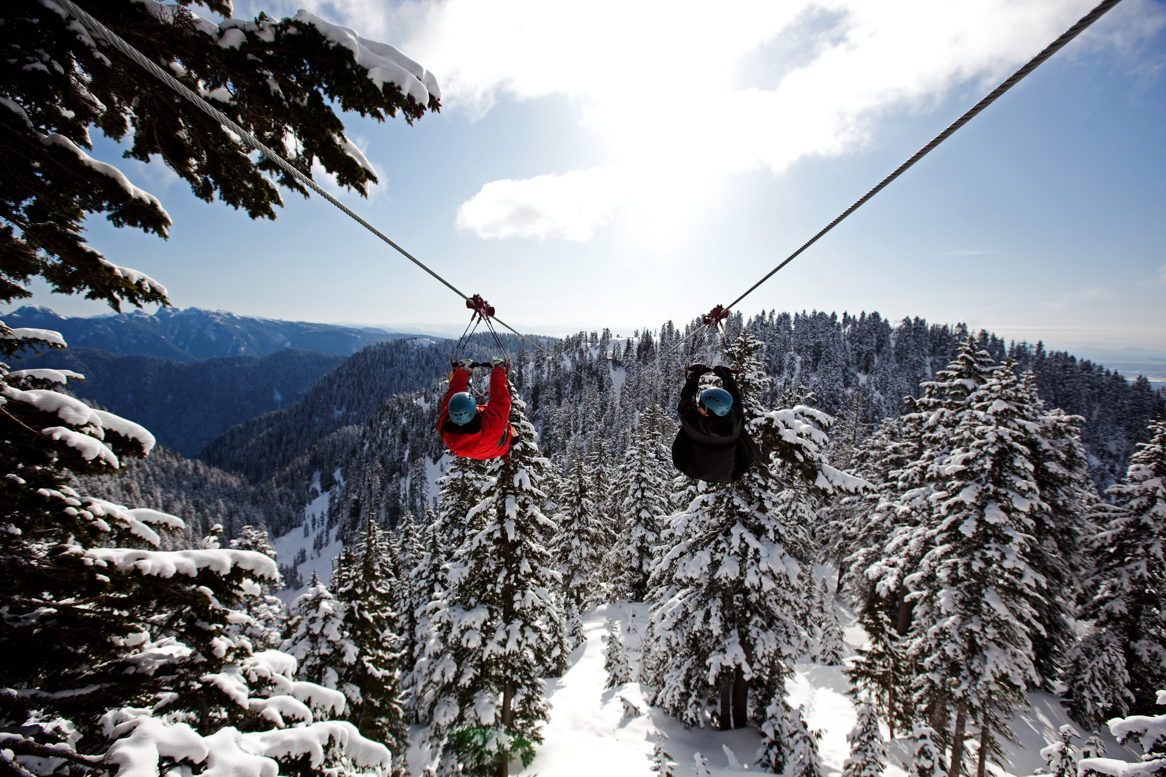 Two people zip lining in winter at Grouse Mountain Image: Destination Vancouver/Grouse Mountain