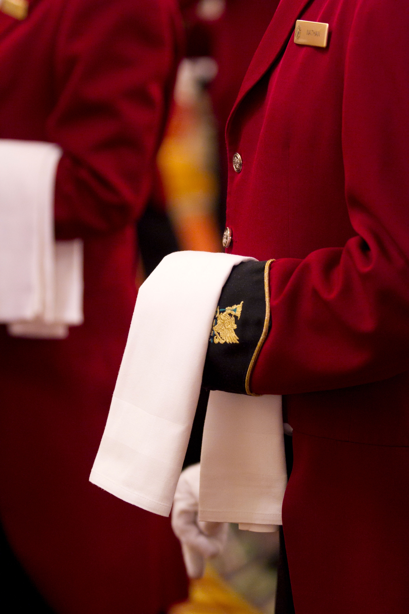 Close up of banquet server with a white cloth draped over arm in classic uniform at Fairmont Hotel Vancouver