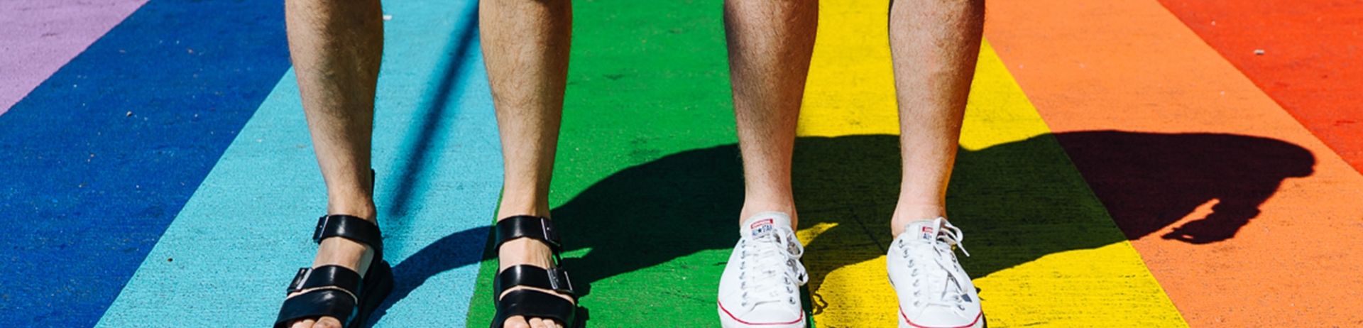 Close up of gay couples' feet on rainbow sidewalk in Vancouver | Fairmont Hotel Vancouver